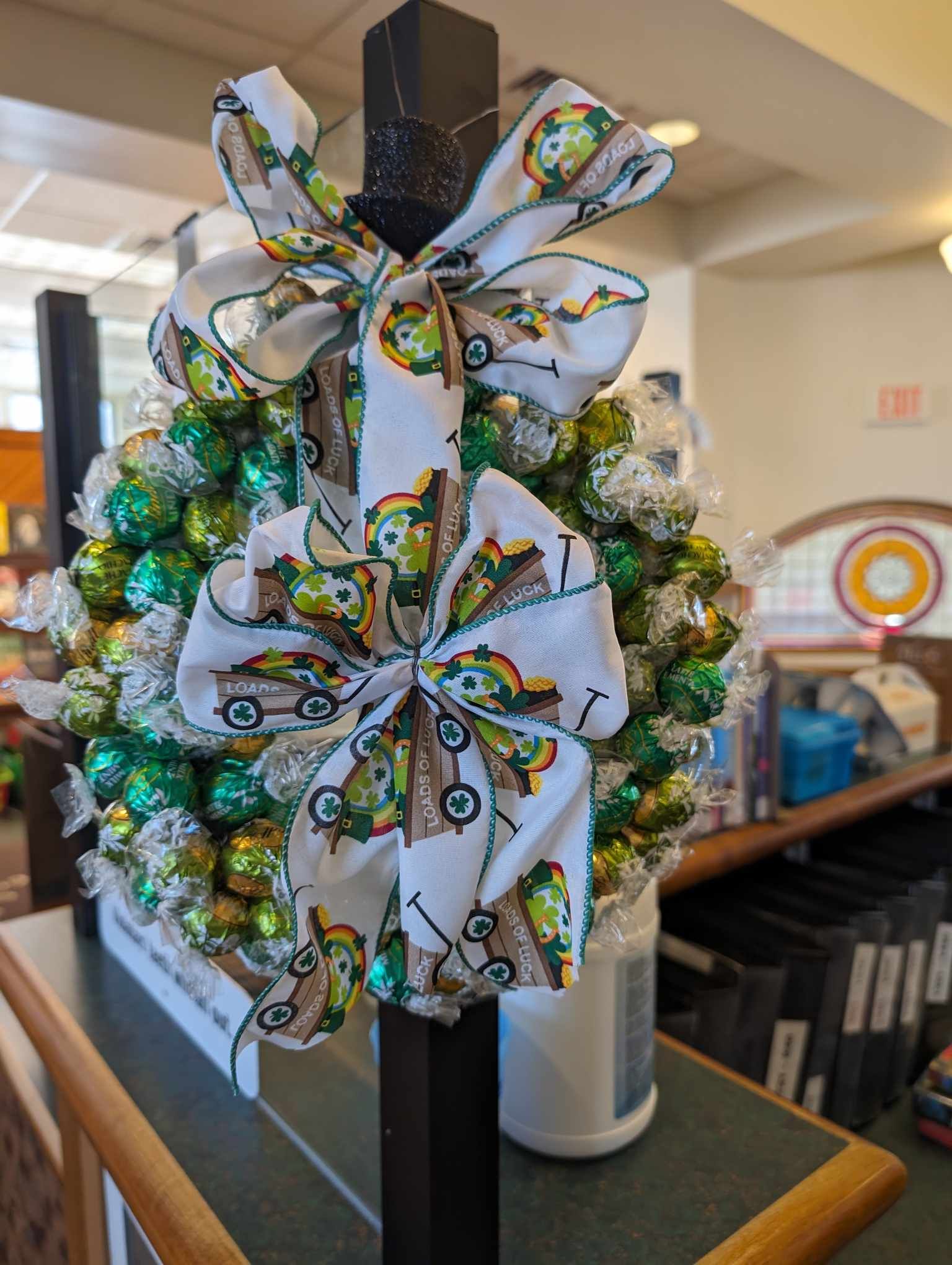 photo of a wreath made of various green wrapped lindt chocolates.