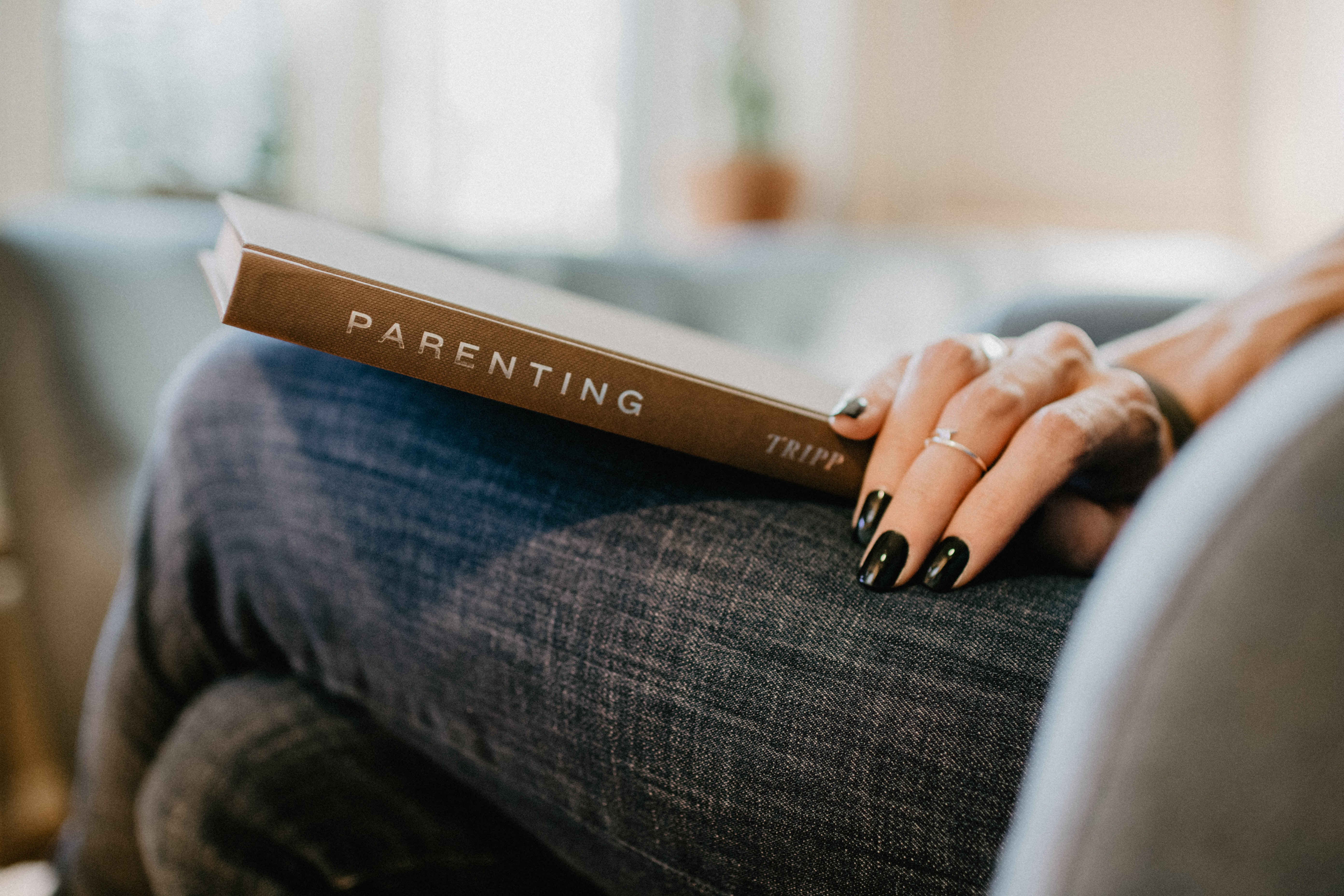 Woman holding parenting book