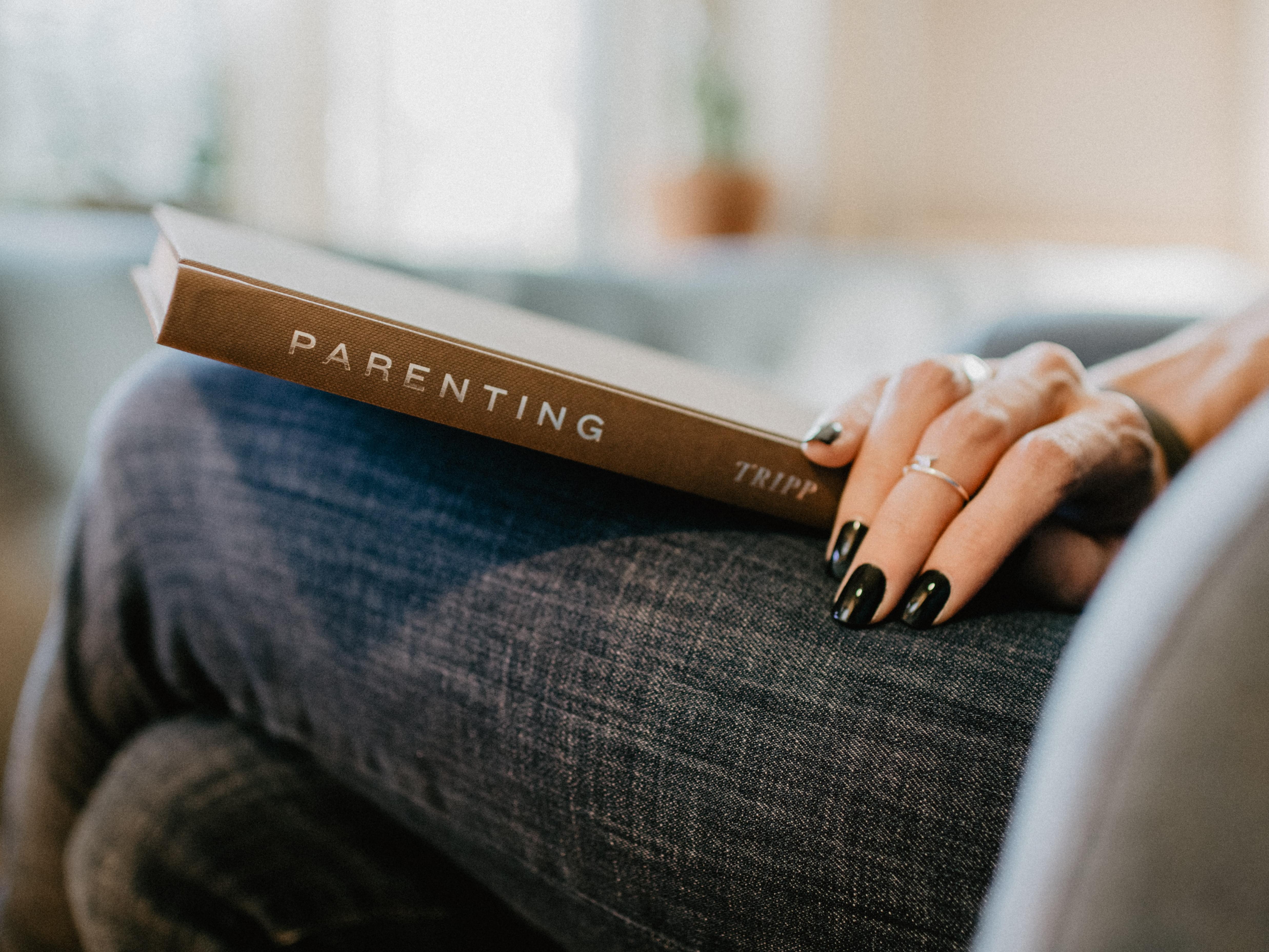 Woman holding parenting book